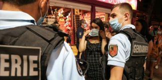 Masks on the street but not at work? Experts urge consistency